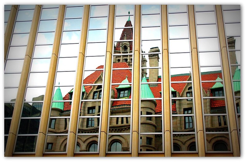 The landmark center in downtown St. Paul reflected in the Travelers Insurance Building. CC BY 2.0 - Teresa Boardman