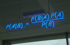 A blue neon sign showing the simple statement of Bayes’s theorem at the offices of HP Autonomy